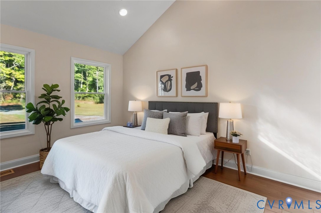 467 Blundon Road Reedville, VA 22539 - Photo 20 of 35 a bedroom with a bed and a potted plant