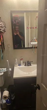 a bathroom with a sink a toilet and a mirror