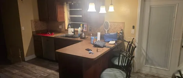 a view of a dining room with a table and chairs