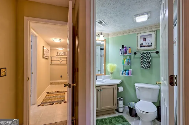 a view of a room that has a large window and wooden floor