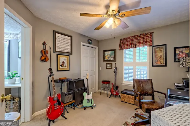 a view of a wooden house with lawn chairs and wooden fence