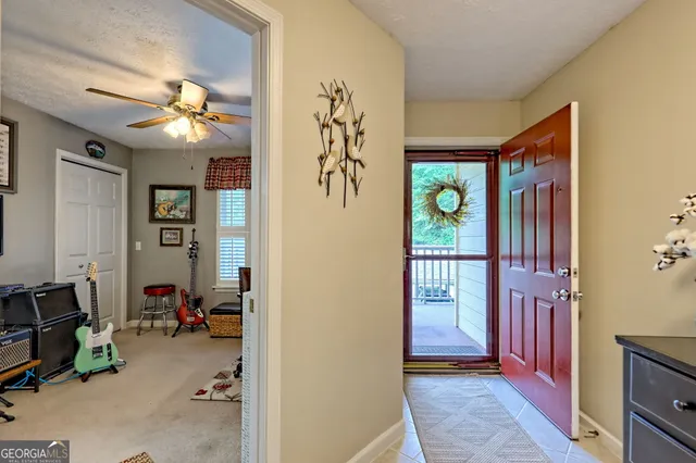 a aerial view of a house with a swimming pool and large trees