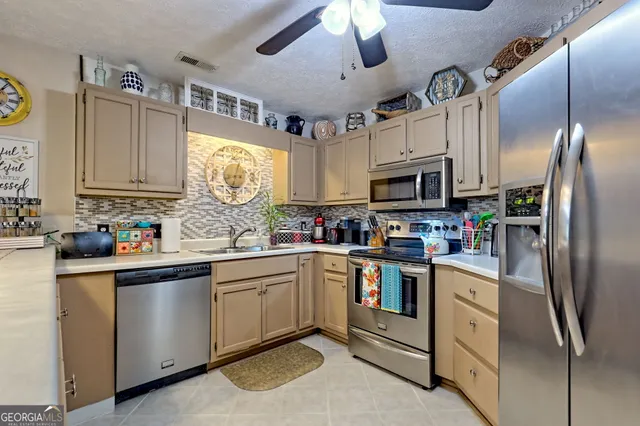 a view of a dining room with furniture a rug and wooden floor