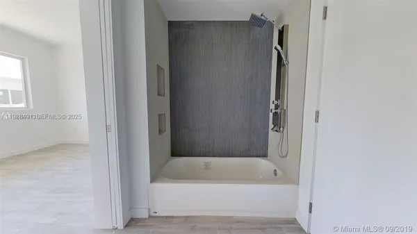 a bathroom with a bathtub and a shower