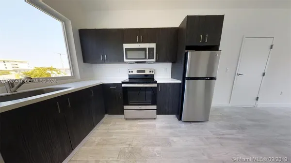 a kitchen with a refrigerator and a sink