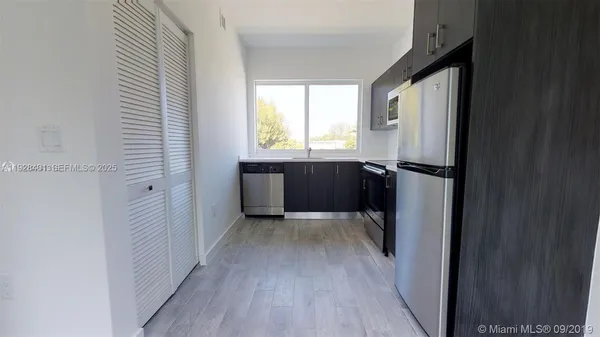 a view of entryway with wooden floor and cabinet