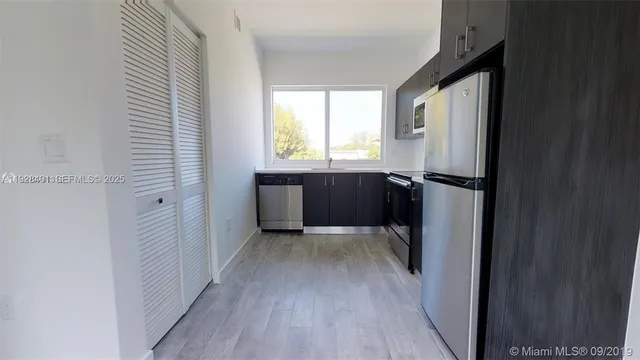 a view of entryway with wooden floor and cabinet
