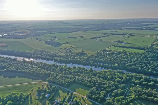 an aerial view of a house with a yard