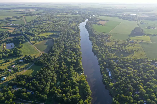 a view of a field with an ocean