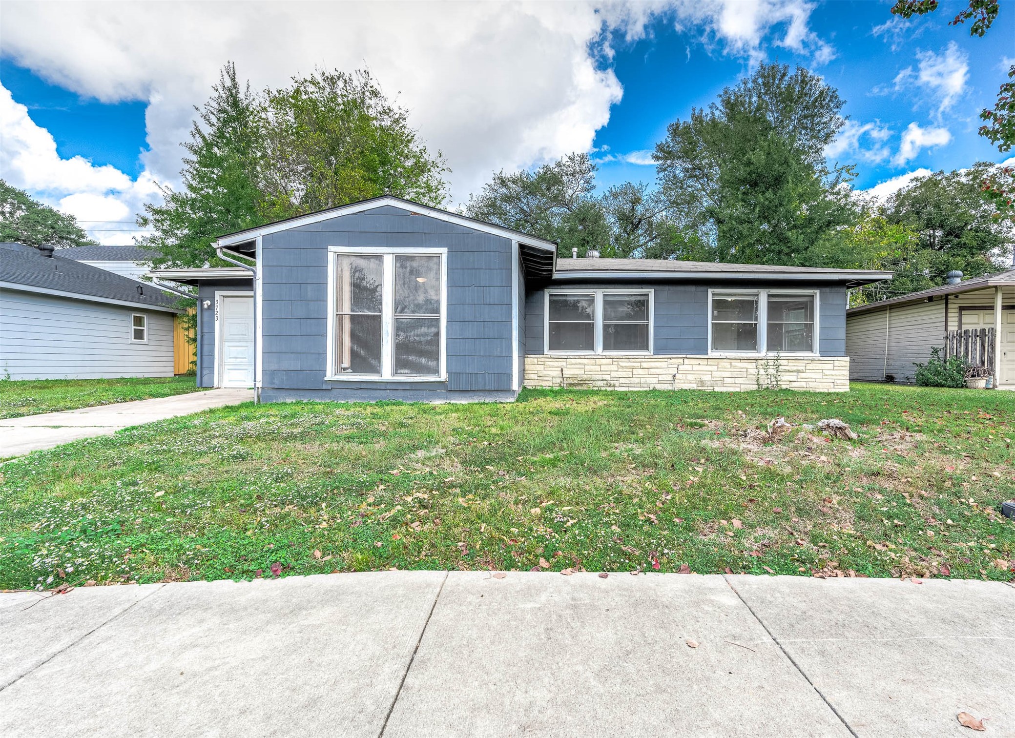 a front view of house with yard and green space