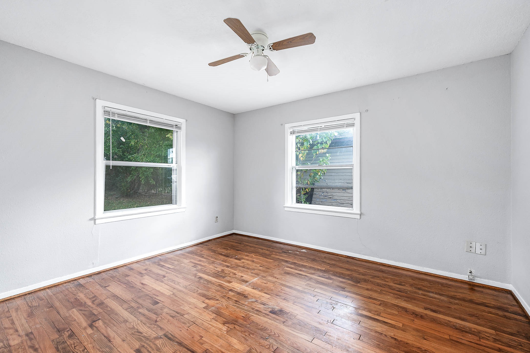 3723 Odin Court Houston, TX 77021 - Photo 12 of 19 a view of an empty room with wooden floor and a window