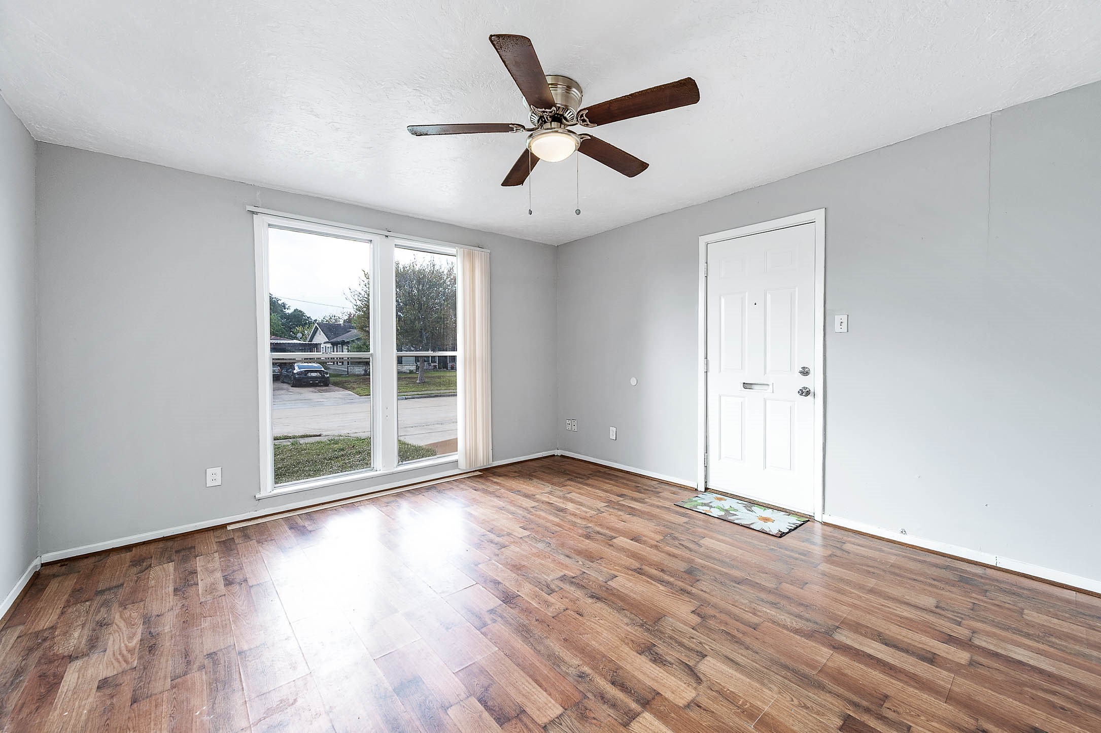 3723 Odin Court Houston, TX 77021 - Photo 2 of 19 an empty room with wooden floor fan and windows