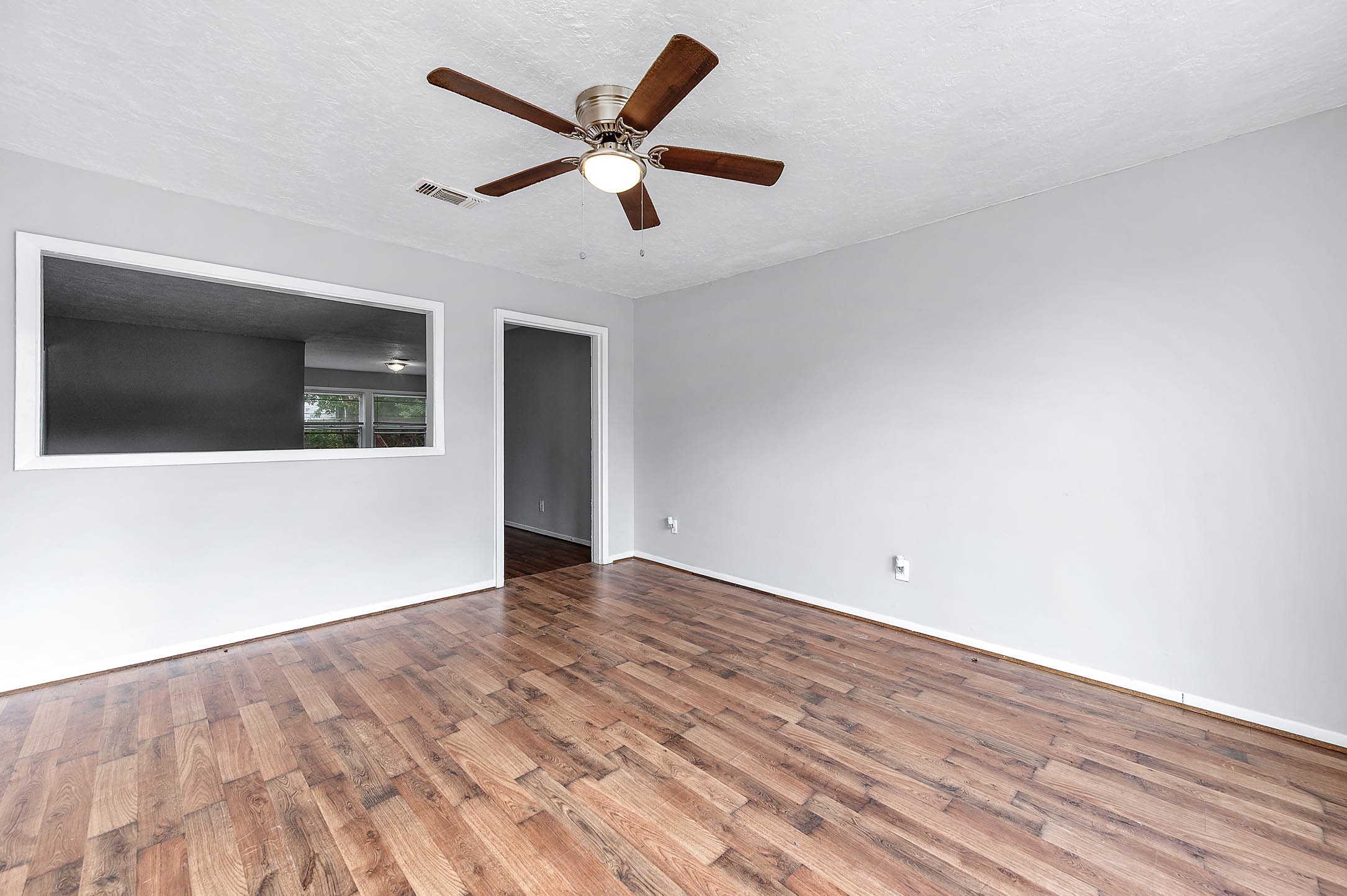 3723 Odin Court Houston, TX 77021 - Photo 3 of 19 an empty room with wooden floor and windows