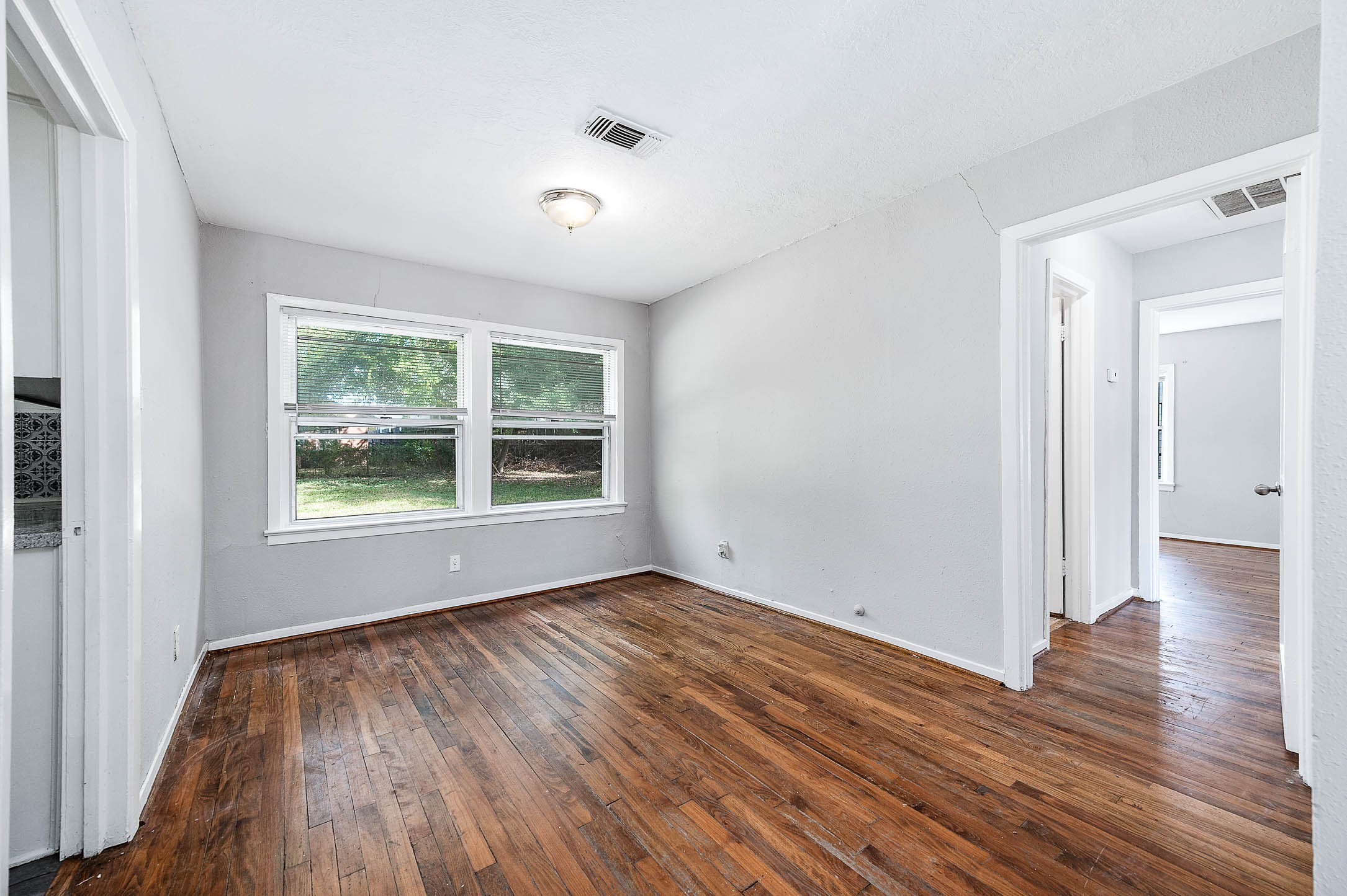 3723 Odin Court Houston, TX 77021 - Photo 6 of 19 a view of an empty room with wooden floor and a window
