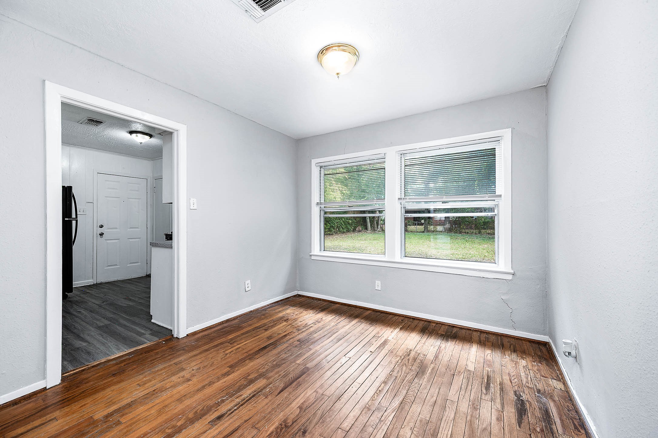 3723 Odin Court Houston, TX 77021 - Photo 8 of 19 an empty room with wooden floor and windows