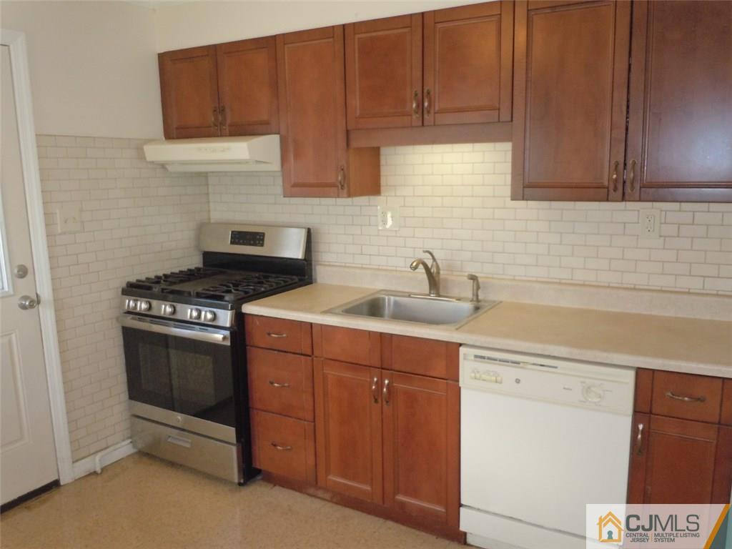29 Richmond Road Edison, NJ 08817 - Photo 2 of 31 a kitchen with stainless steel appliances a stove a sink and cabinets
