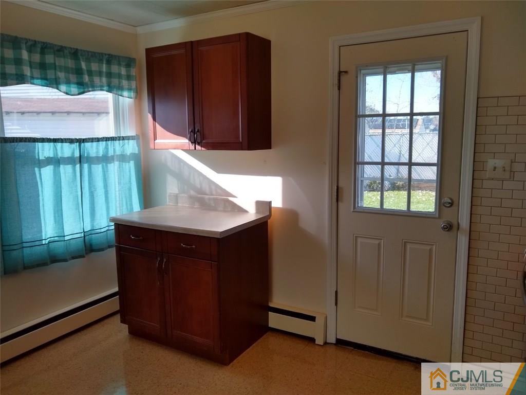 29 Richmond Road Edison, NJ 08817 - Photo 7 of 31 a kitchen with a wooden cabinets and a window