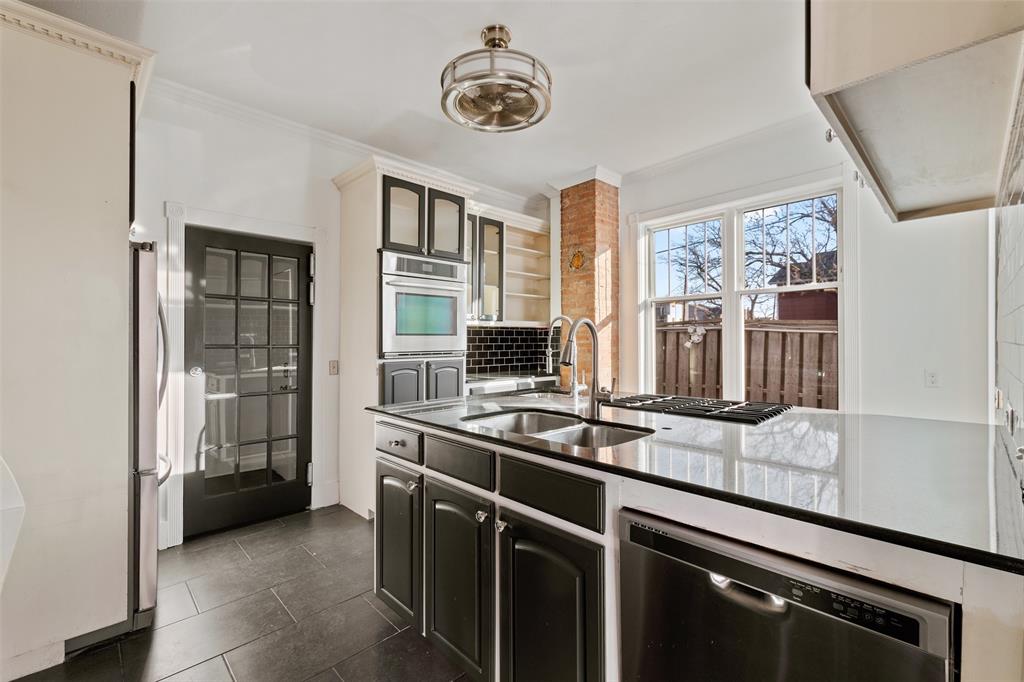 a kitchen with stainless steel appliances granite countertop a stove and a sink
