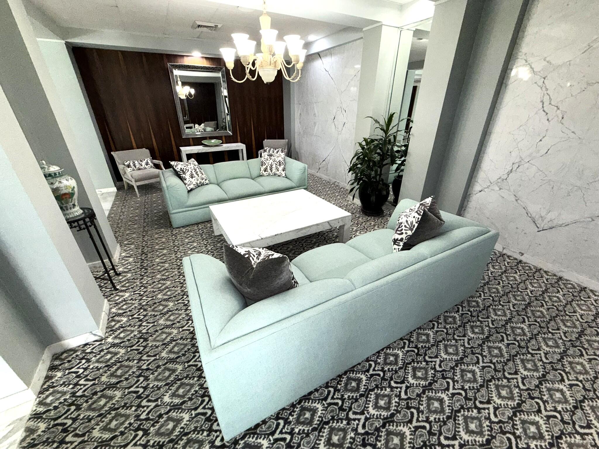 2860 South Ocean Boulevard, Unit 415 Palm Beach, FL 33480 - Photo 20 of 24 a living room with furniture and a chandelier