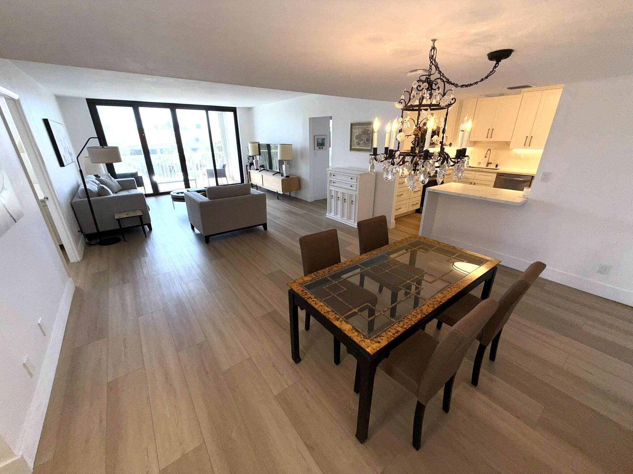 2860 South Ocean Boulevard, Unit 415 Palm Beach, FL 33480 - Photo 7 of 24 a living room with furniture and a chandelier