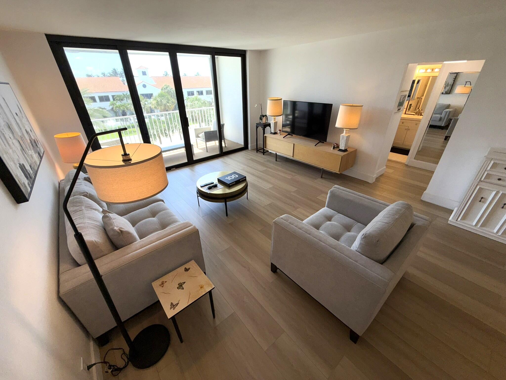 2860 South Ocean Boulevard, Unit 415 Palm Beach, FL 33480 - Photo 8 of 24 a living room with furniture and a flat screen tv