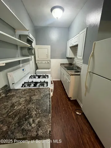 a kitchen with stove a refrigerator and a stove