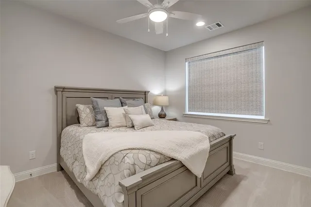 a bedroom with a bed and a large window