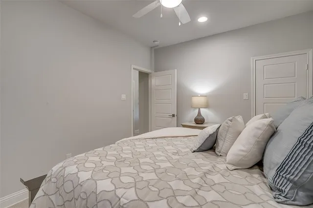 a bedroom with a bed and a lamp