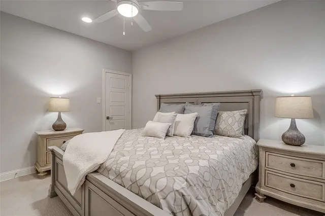 a bedroom with a bed and a lamp