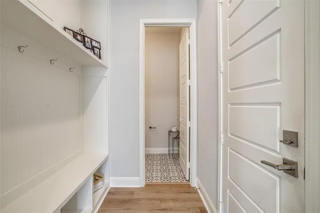 a view of a hallway with closet and wooden floor