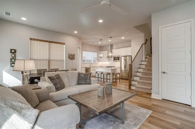 a living room with furniture and wooden floor