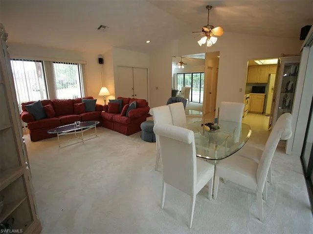 a living room with furniture a lamp and a chandelier
