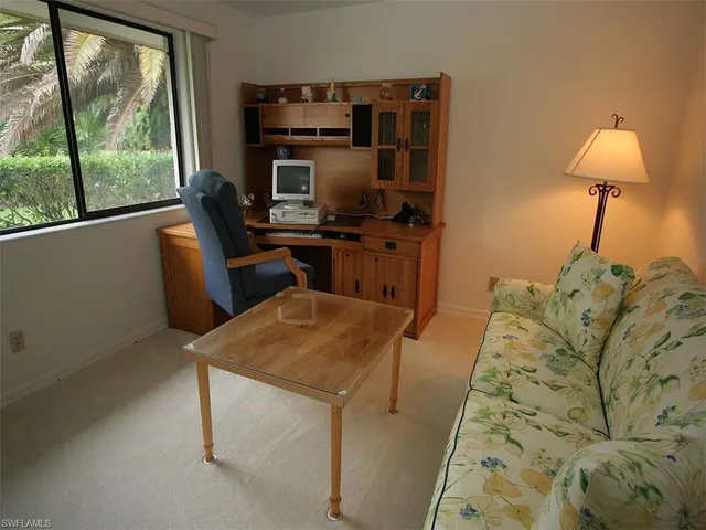 a bedroom with a bed and a night stand