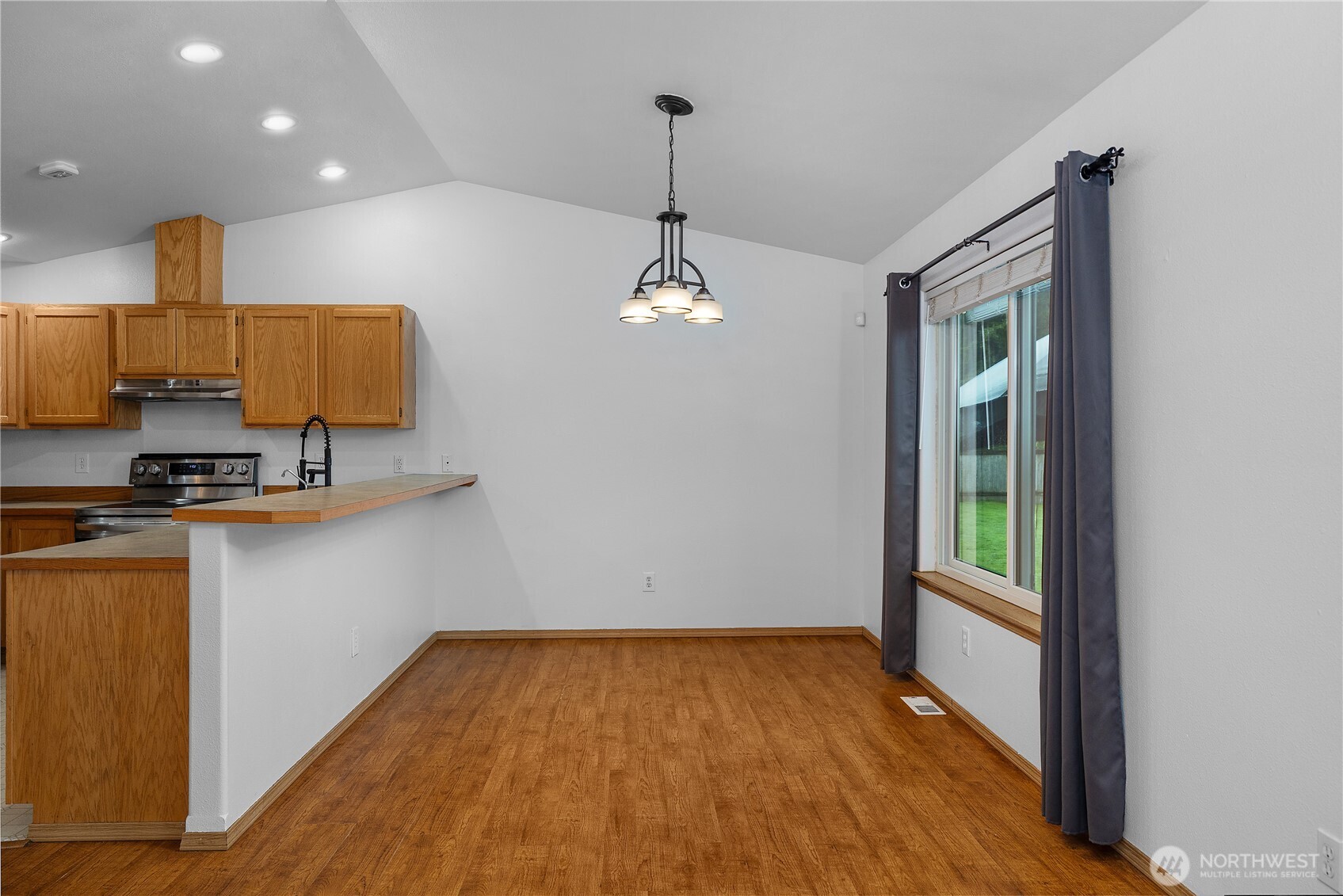 7606 187th Avenue Southwest Rochester, WA 98579 - Photo 12 of 28 a very nice looking room with a large window and chandelier