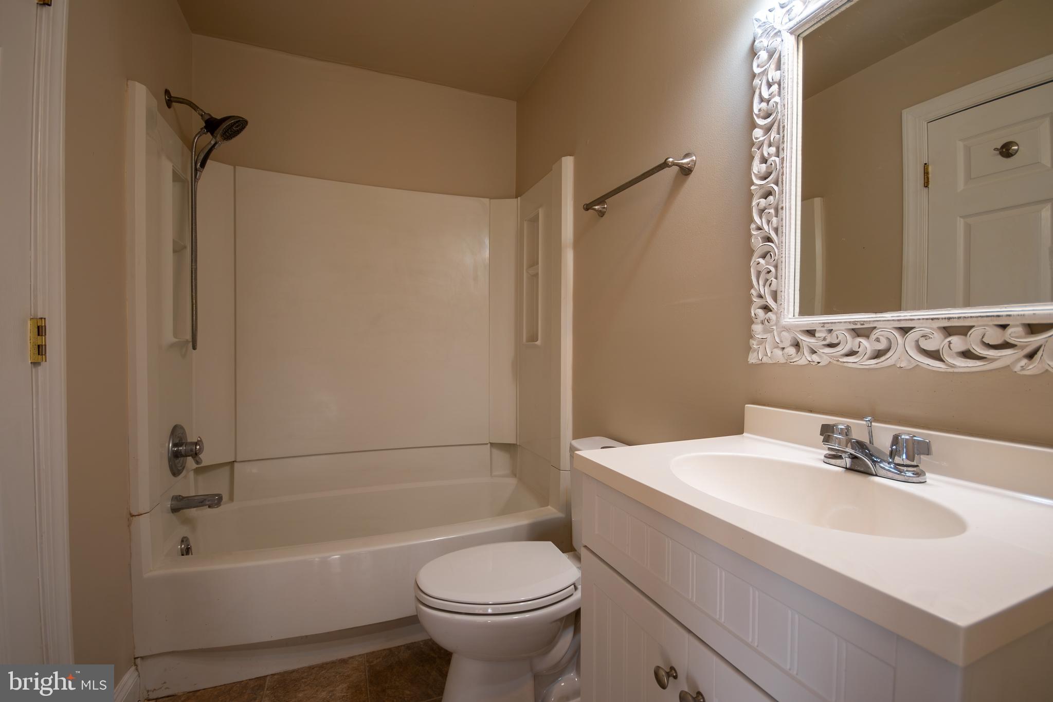 219 Virginia Street Strasburg, VA 22657 - Photo 11 of 29 a bathroom with a sink toilet and shower