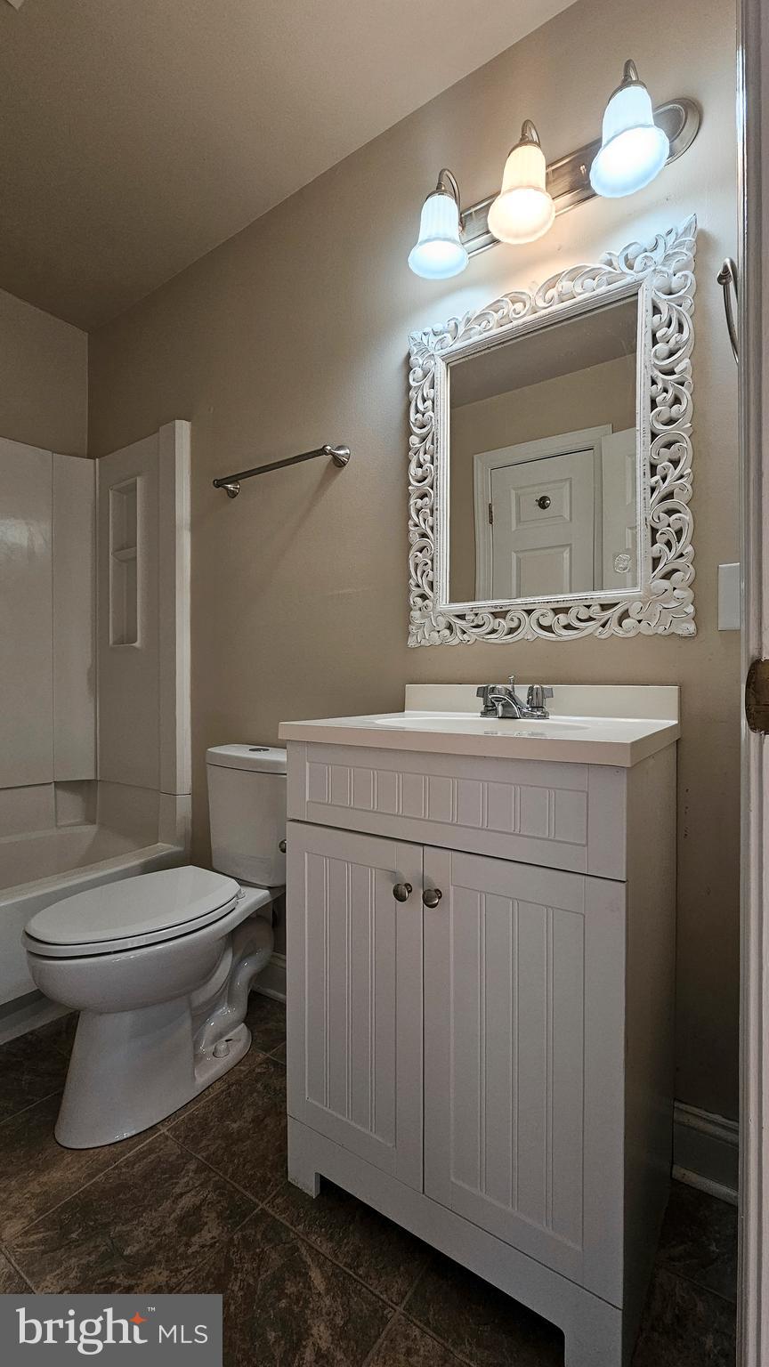 219 Virginia Street Strasburg, VA 22657 - Photo 12 of 29 a bathroom with a sink a toilet and mirror