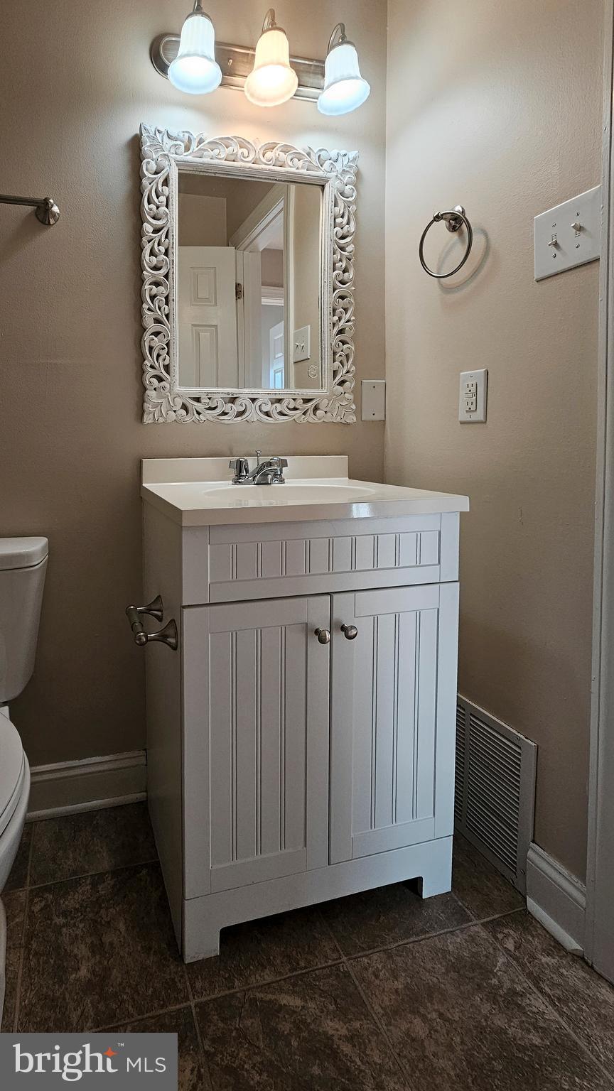219 Virginia Street Strasburg, VA 22657 - Photo 13 of 29 a bathroom with a sink and a mirror