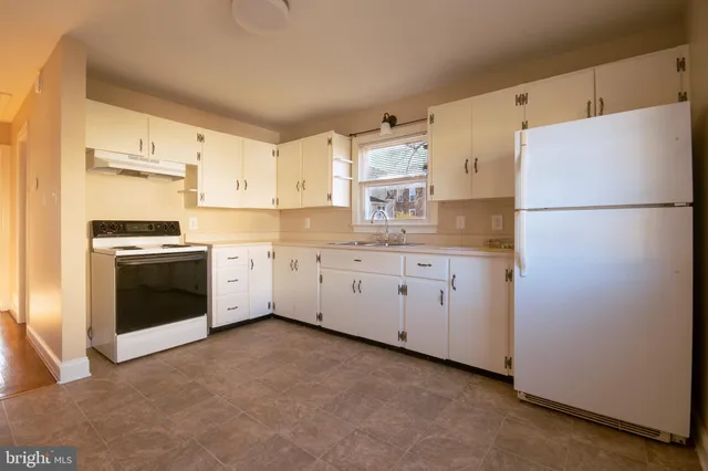 a kitchen with cabinets and a stove top oven
