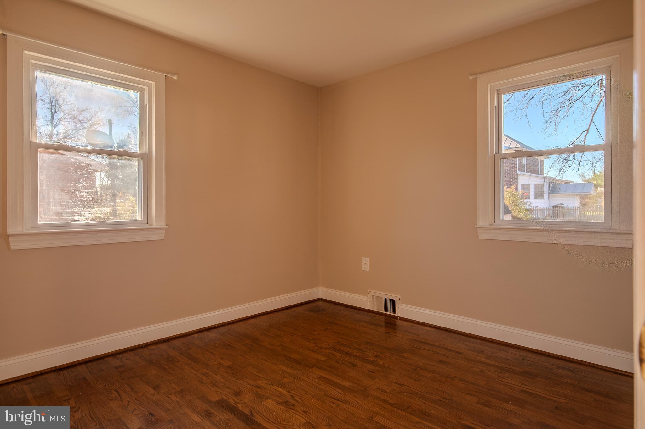 219 Virginia Street Strasburg, VA 22657 - Photo 8 of 29 a view of an empty room with wooden floor and a window
