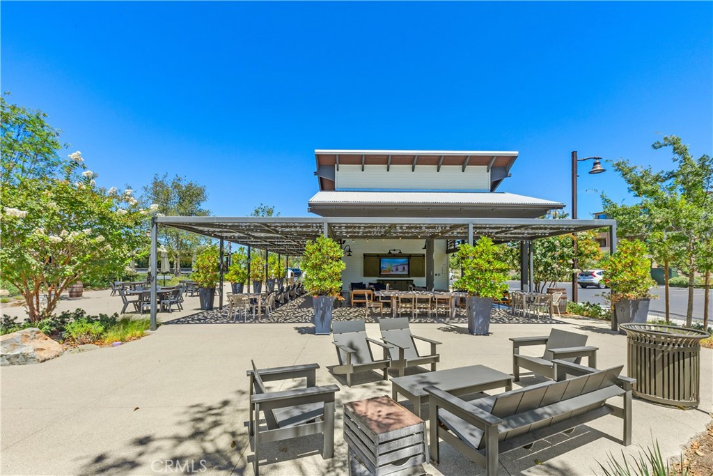 78 Patria Rancho Mission Viejo, CA 92694 - Photo 50 of 56 a view of a patio with table and chairs potted plants and a large tree