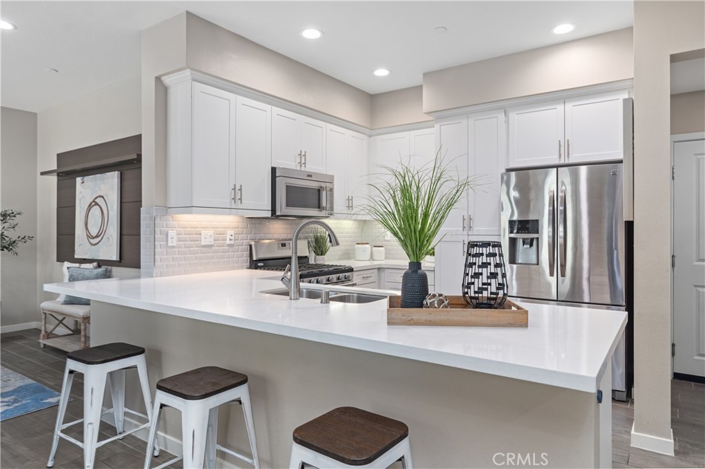 78 Patria Rancho Mission Viejo, CA 92694 - Photo 5 of 56 a kitchen with stainless steel appliances a sink a counter top space cabinets and a potted plant