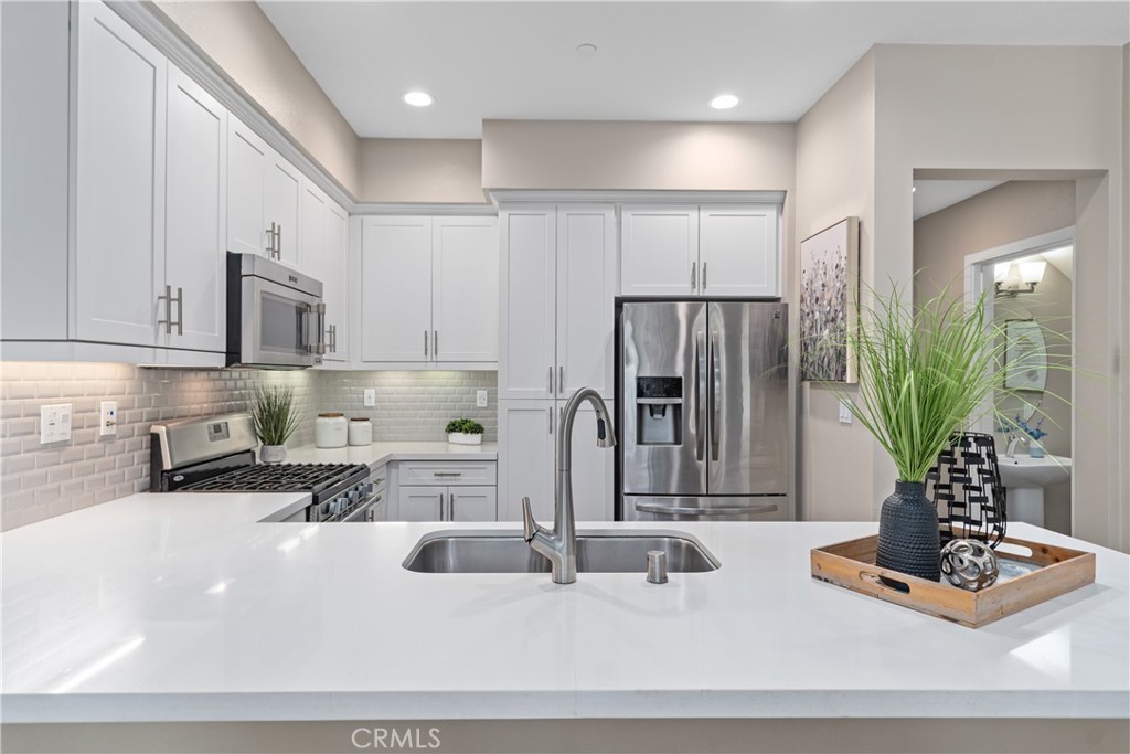 78 Patria Rancho Mission Viejo, CA 92694 - Photo 6 of 56 a kitchen with counter top space cabinets and stainless steel appliances