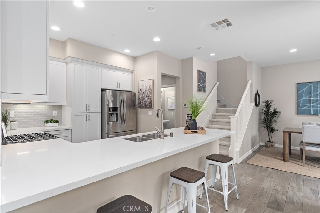 78 Patria Rancho Mission Viejo, CA 92694 - Photo 7 of 56 a kitchen with stainless steel appliances kitchen island granite countertop a sink and cabinets