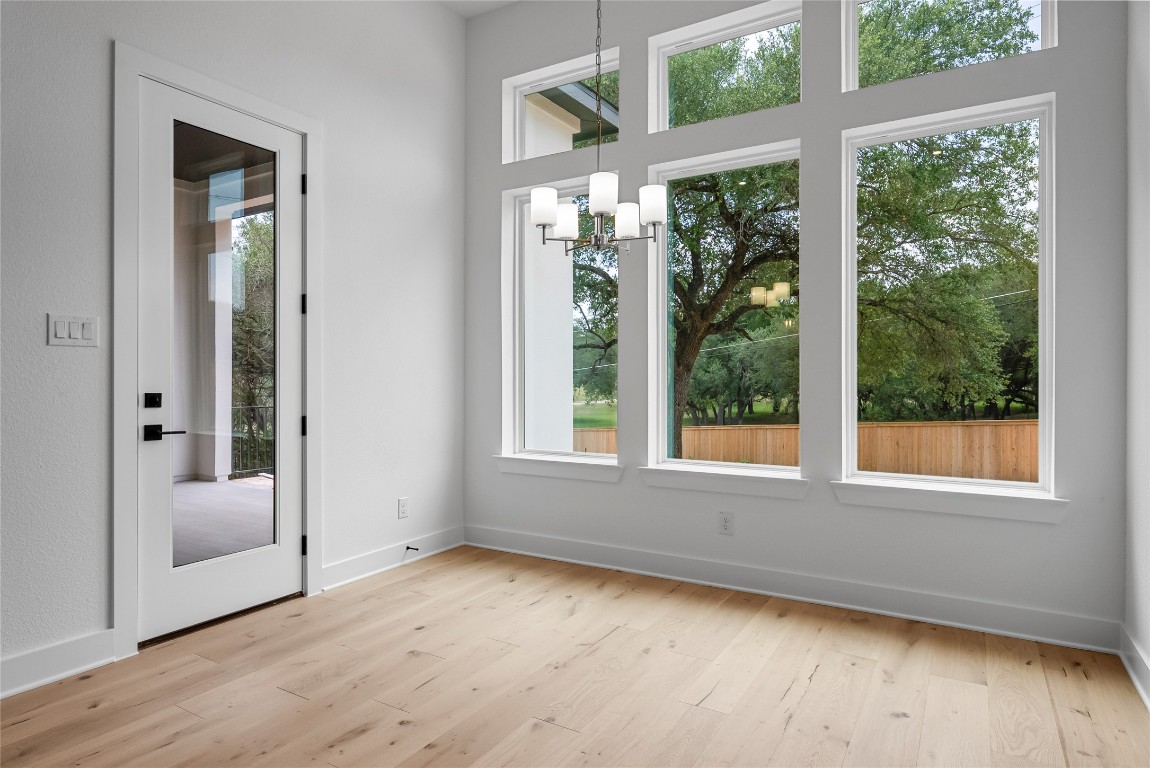 1304 Novara Trail Leander, TX 78641 - Photo 11 of 25 an empty room with wooden floor and windows