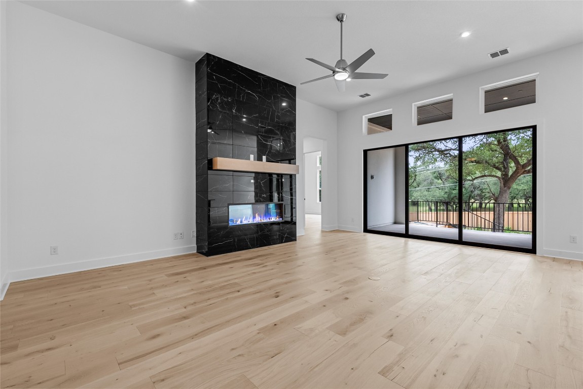 1304 Novara Trail Leander, TX 78641 - Photo 2 of 25 a view of an empty room with a window and wooden floor