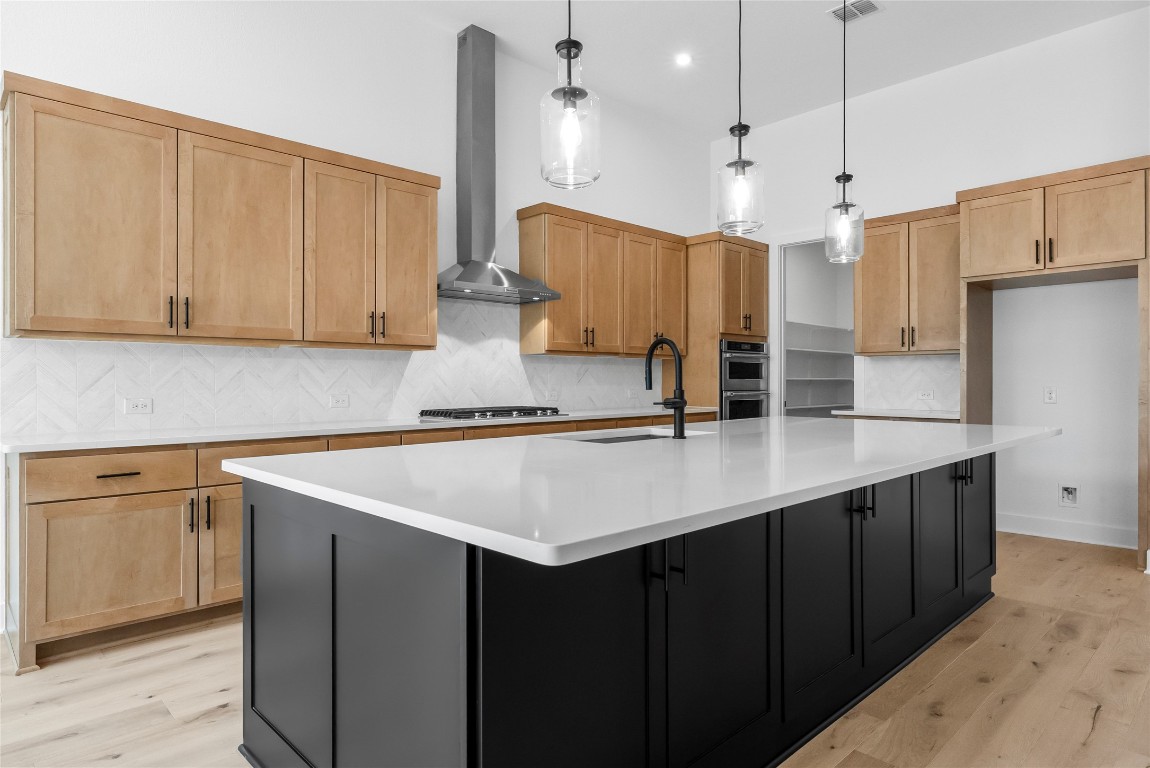 1304 Novara Trail Leander, TX 78641 - Photo 4 of 25 a kitchen with stainless steel appliances granite countertop a sink a oven a refrigerator and white cabinets