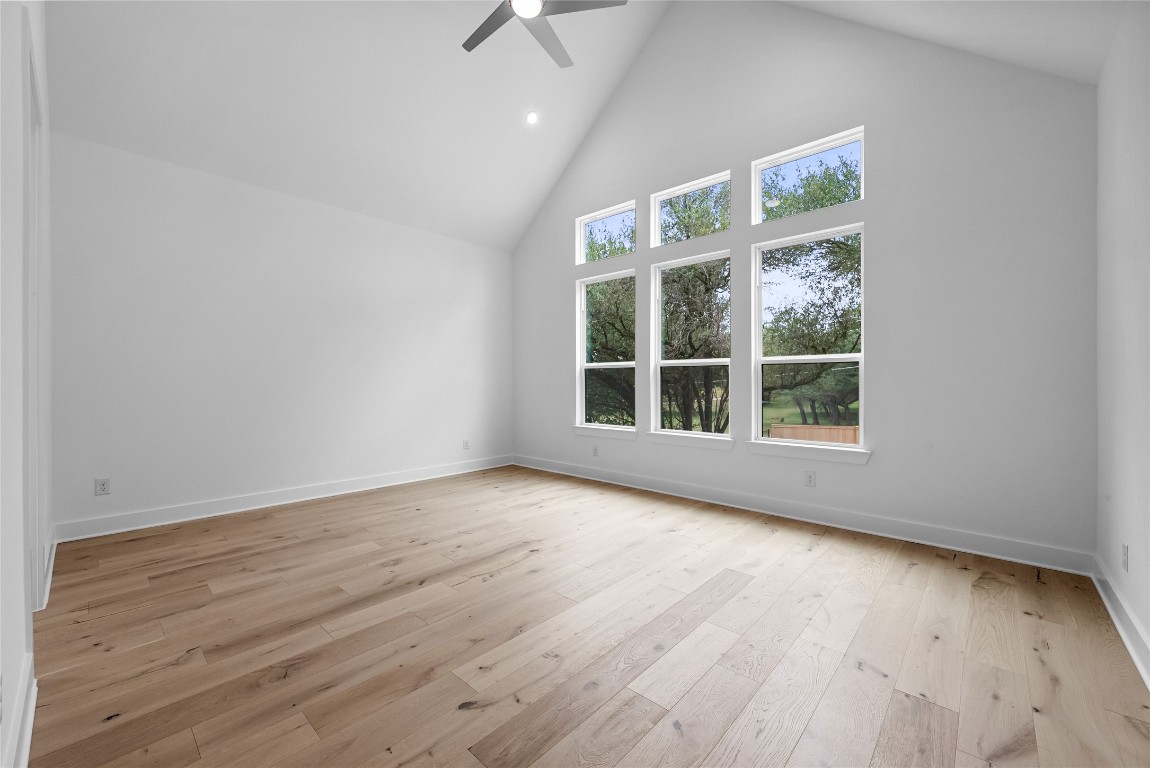 1304 Novara Trail Leander, TX 78641 - Photo 5 of 25 an empty room with wooden floor and windows