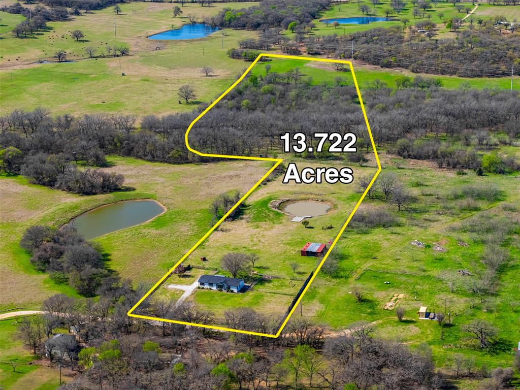 181 Pr 125 Whitney, TX 76692 - Photo 3 of 34 Overhead view of stocked pond, home, and outbuildings at 181 Private Road 125 Whitney TX