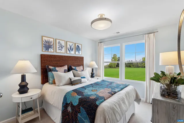 a bedroom with a bed and a lamp