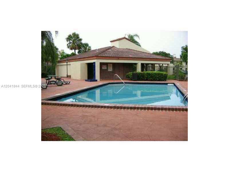 8610 Southwest 149th Avenue, Unit 504 Miami, FL 33193 - Photo 3 of 13 a view of a house with a yard